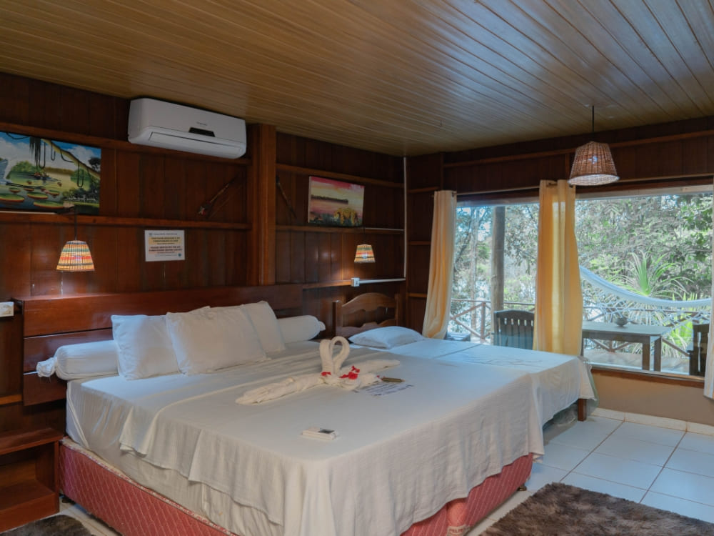 A comfortable and affordable bungalow bedroom with two beds at Amazon Turtle Lodge in Brazil. A comfortable and affordable bungalow bedroom with two beds at Amazon Turtle Lodge in Brazil.