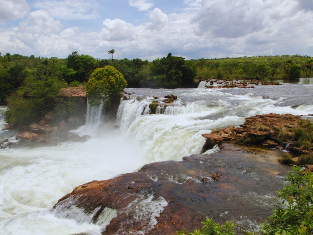 The powerful horseshoe-shaped Velha Waterfall cascading over rocky cliffs along the well-preserved Novo River 