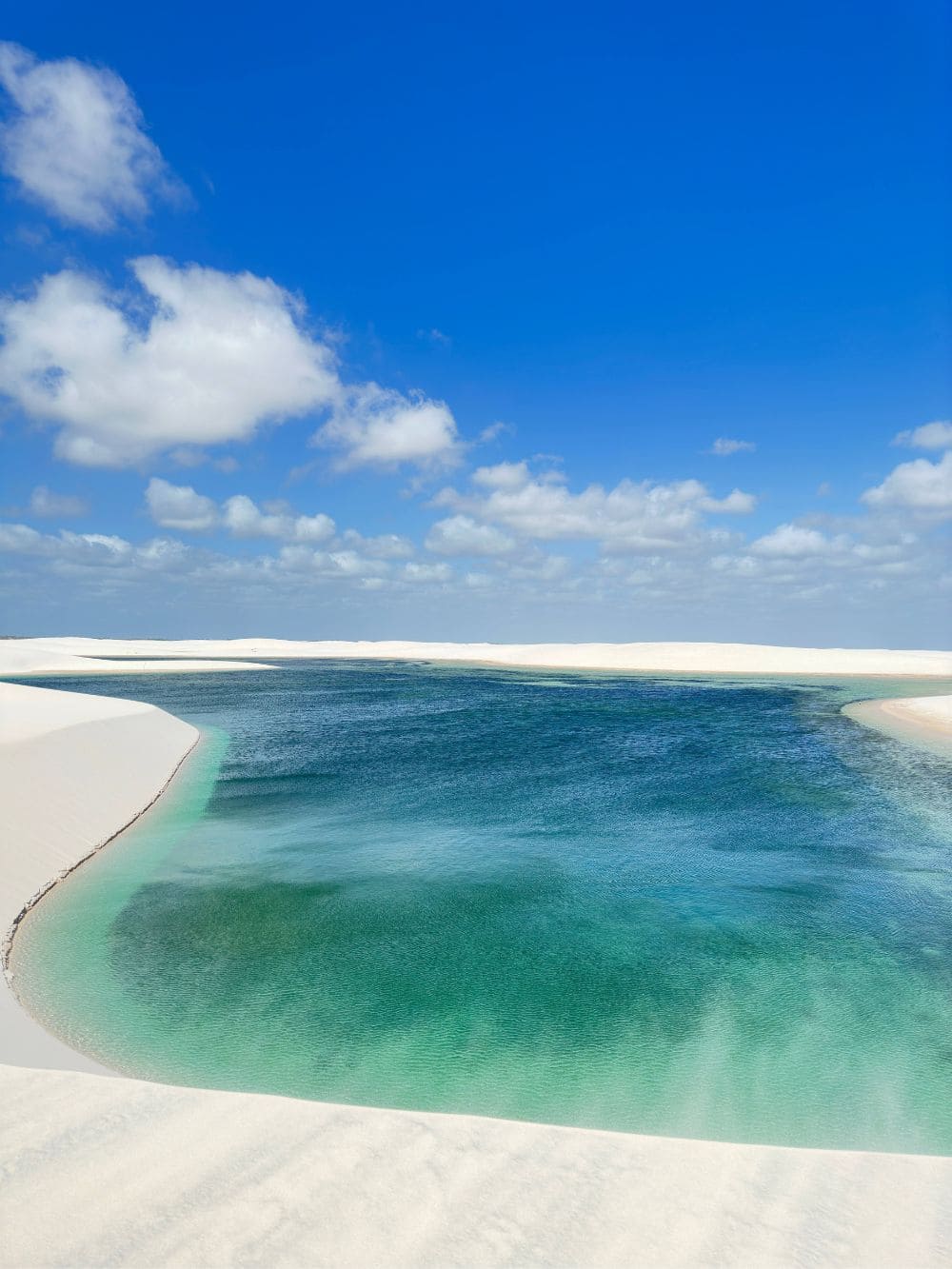 A pristine turquoise lagoon rests between the expansive white sand dunes near Barreirinhas.