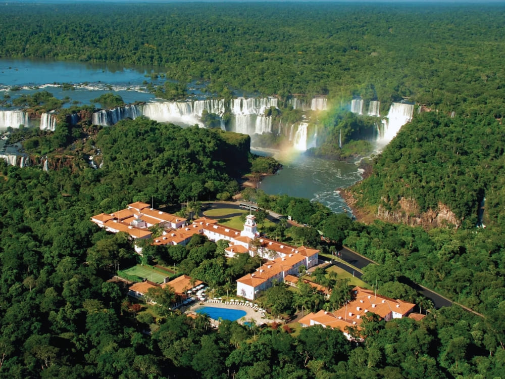 Aerial view of Belmond Hotel das Cataratas nestled in the forest near the Iguacu Falls. Aerial view of Belmond Hotel das Cataratas nestled in the forest near the Iguacu Falls.