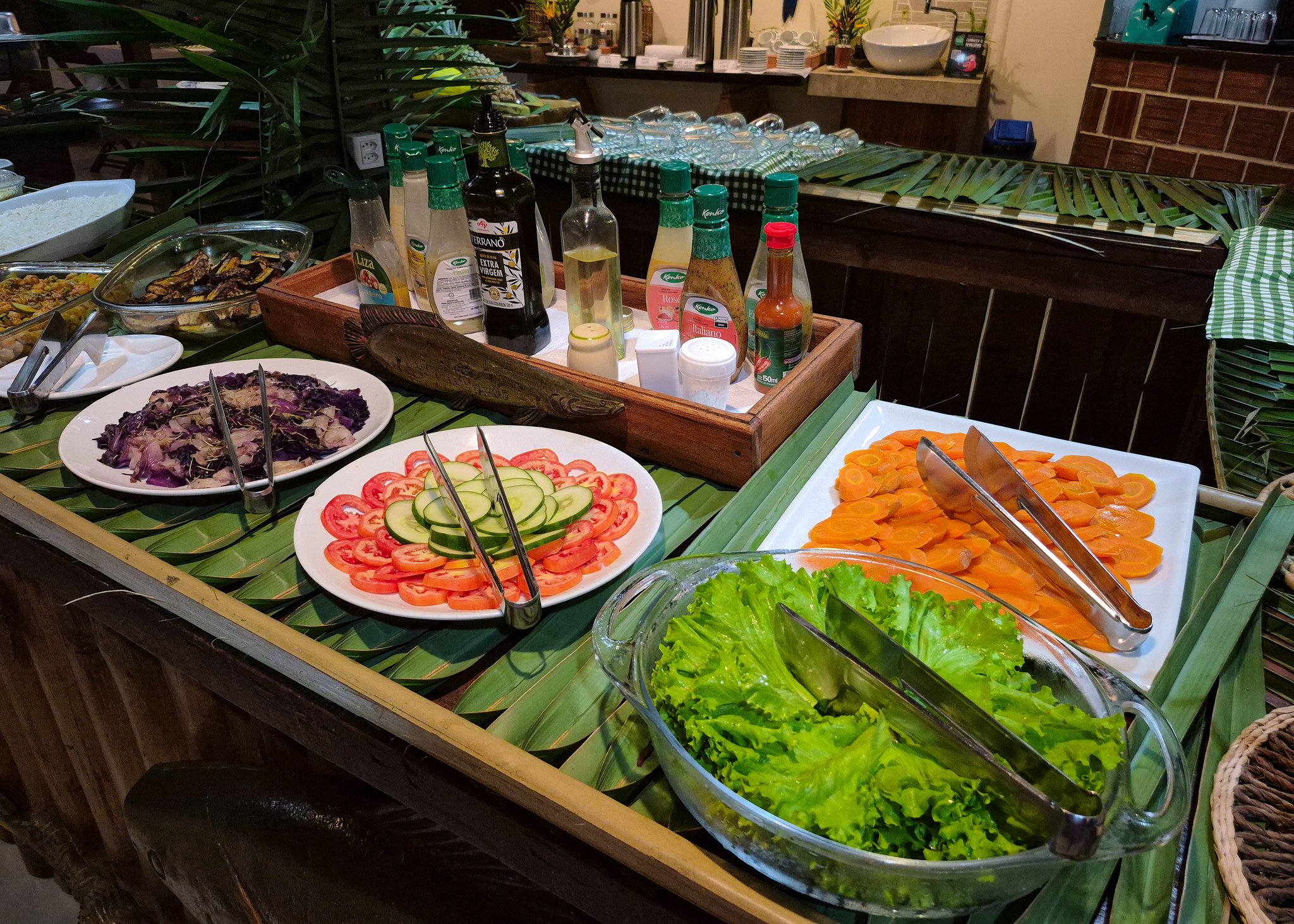 Fresh salads on banana leaves round out the lodge's hearty regional spread. Colourful salad buffet of cabbage, tomato, cucumber and carrot on a banana-leaf counter at the lodge