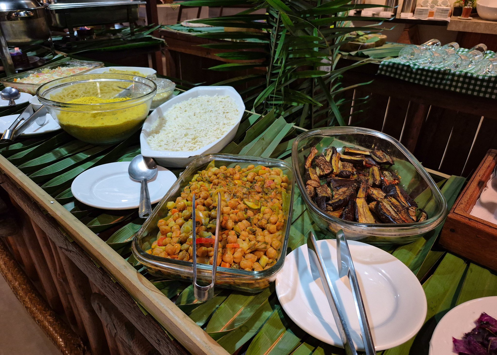 Warm dishes of rice, stews and grilled vegetables keep adventurers well fed. Hot buffet of rice, chickpea stew and grilled eggplant on banana leaves at the lodge