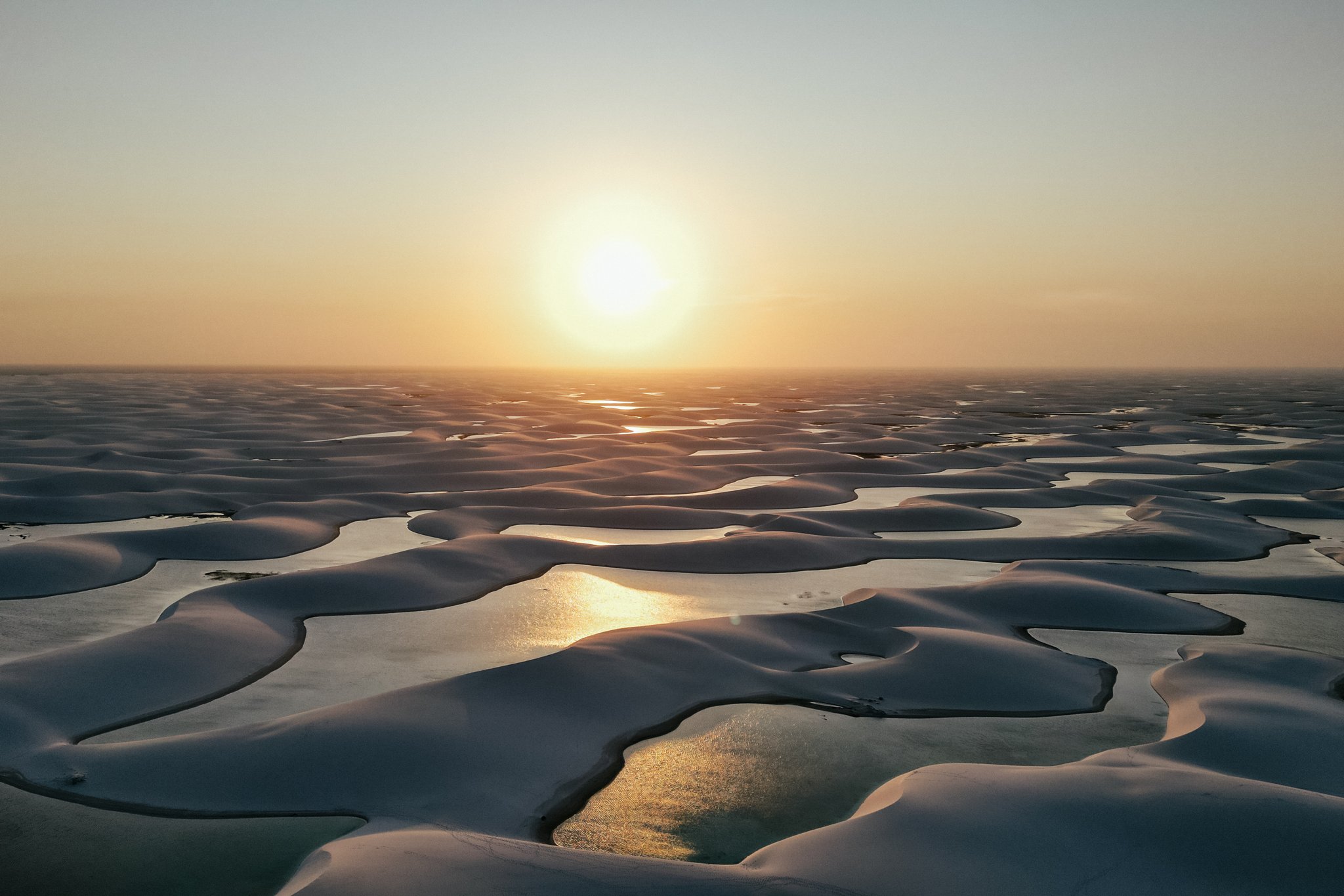Golden light catches every lagoon at once — the dunes of Lençóis Maranhenses at their most otherworldly. Photo: Drs Producoes Photo 1