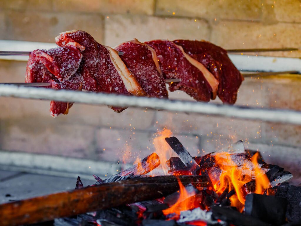 Salt, fire, and ember-kissed beef — dinner earned after a day on the river. Photo 2